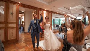 Spacious wedding reception hall with elegant wood paneling and lighting.