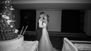 Black and white photo of couples dancing during an elegant wedding reception.
