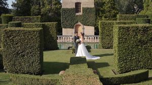 Beautiful garden wedding venue with manicured hedges and formal landscaping.