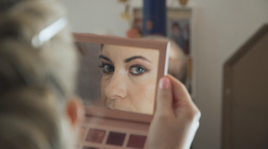 Wedding makeup and beauty preparation scene with soft natural lighting.