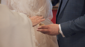 Close-up details of a white wedding dress and formal attire.