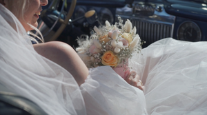 Wedding dress details with delicate lace and tulle fabric flowing in natural light.