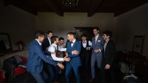 Wedding party members in formal attire gather for candid moments before the ceremony.