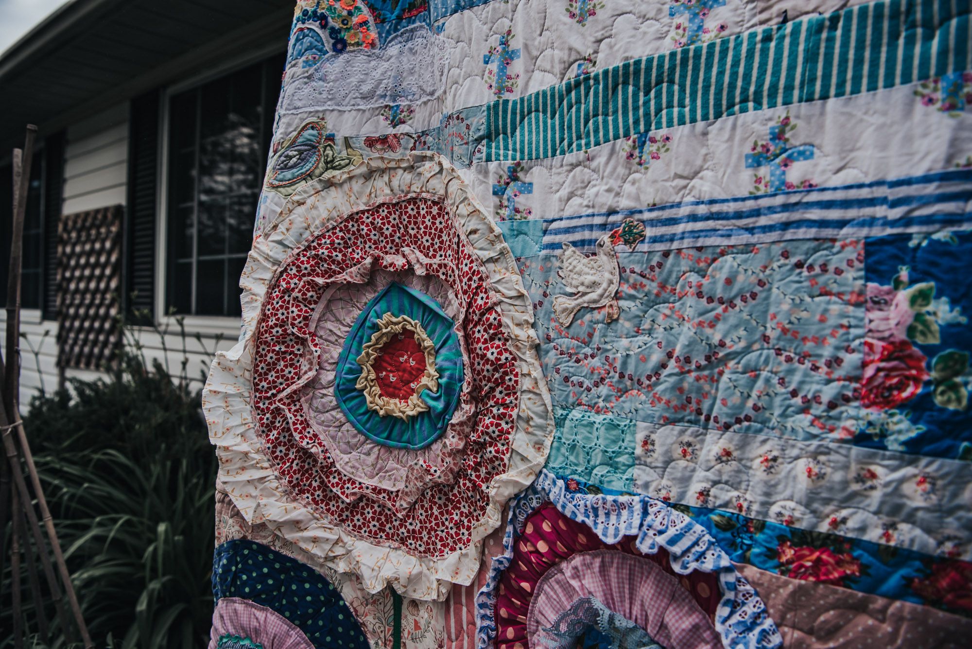 Large flower applique in a custom memory quilt.