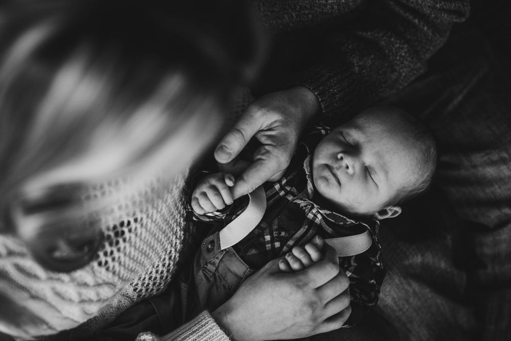 Black and white image of joyful interaction with a smiling baby.