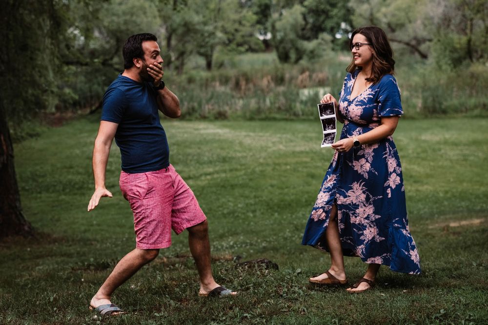 Candid outdoor moment in a park with floral dress and pink shorts.