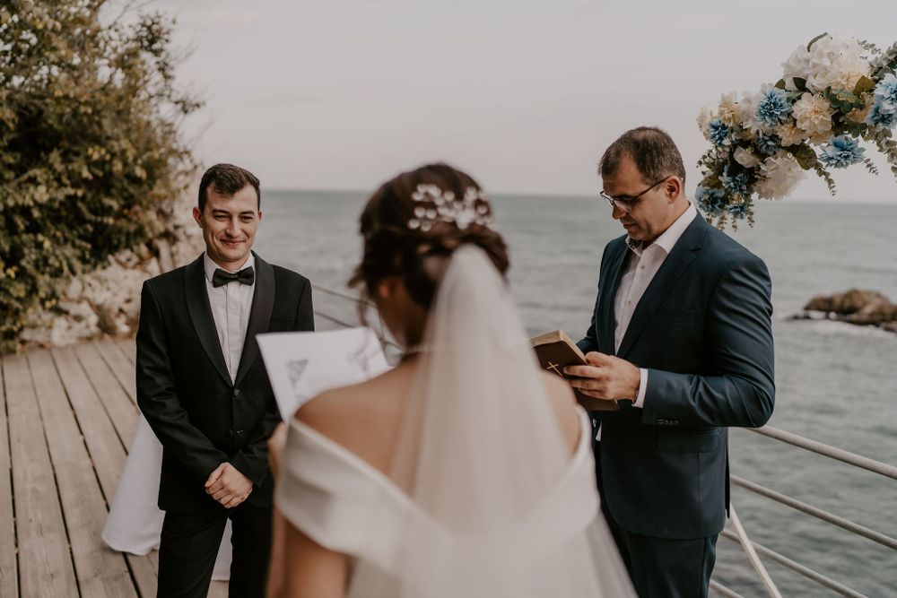 Emotional wedding ceremony moments captured during vow exchange on waterfront deck.