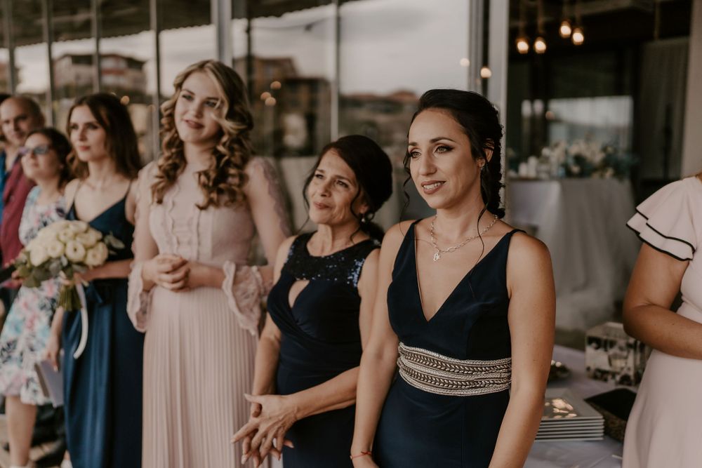 Wedding party members in elegant evening attire gather during the celebration.