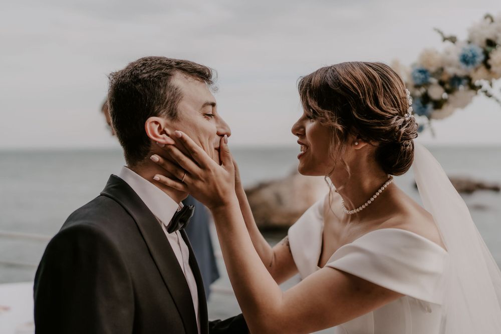 An intimate moment shared between newlyweds during their waterfront wedding ceremony.