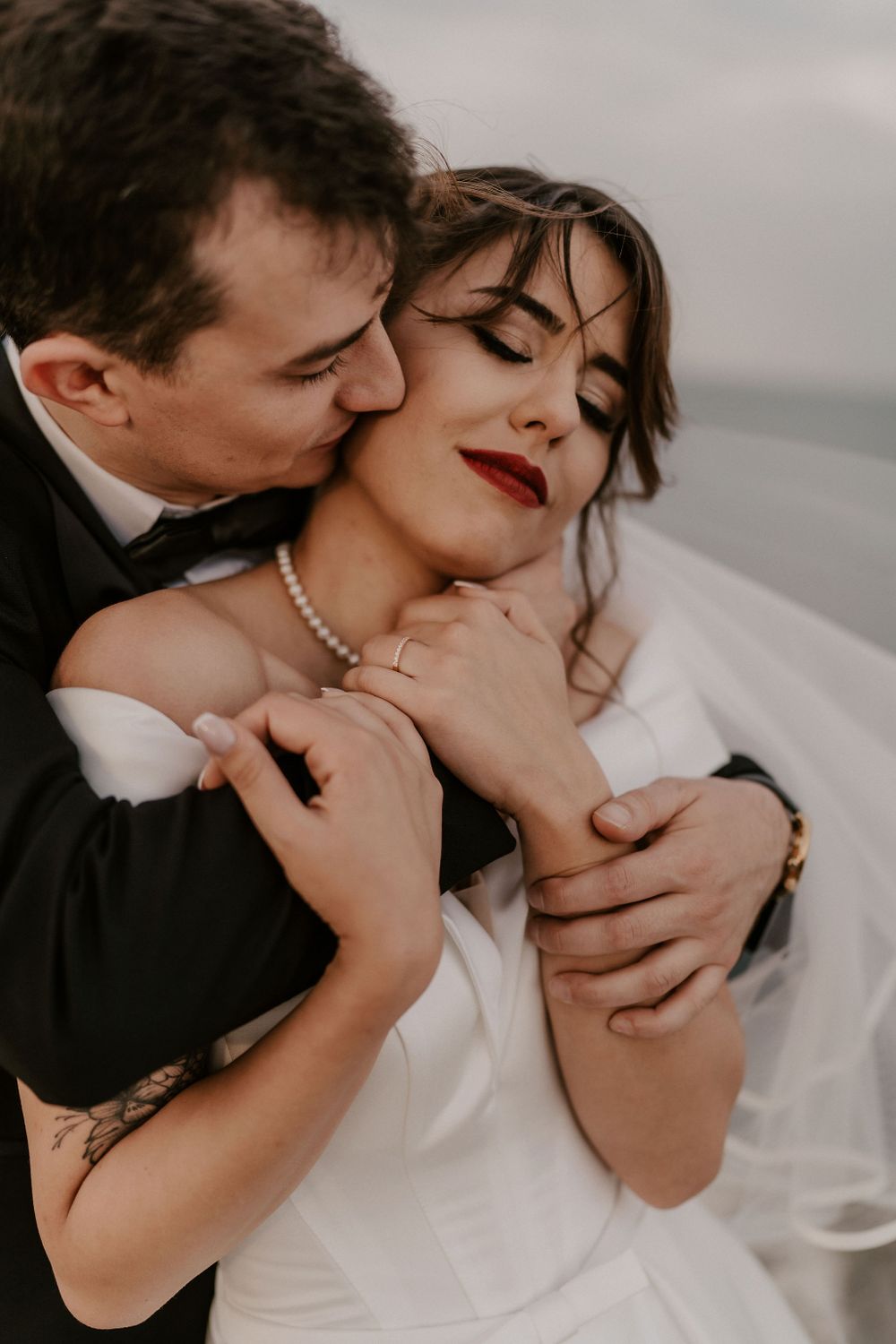 Intimate close-up of wedding couple sharing a passionate moment by the sea.
