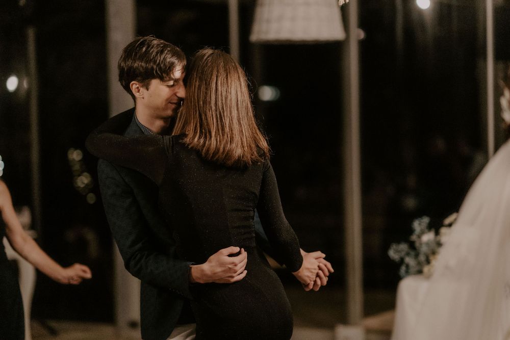 Couple dancing together in formal attire at an evening event.