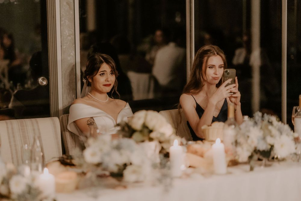 Wedding reception decor with white floral arrangements and soft lighting.