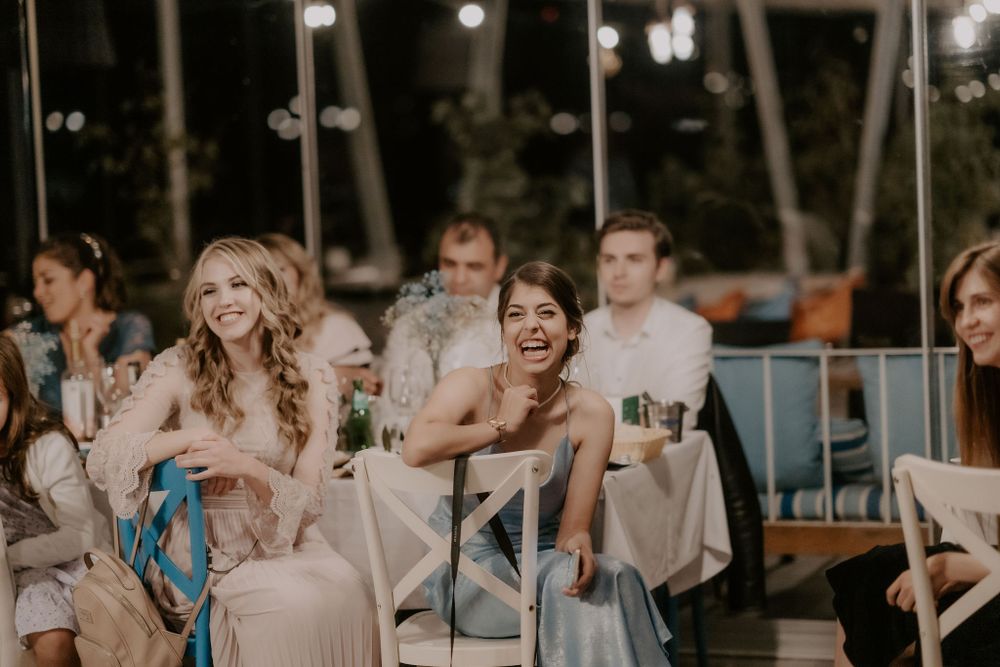 Wedding guests celebrating at tables during an evening reception.