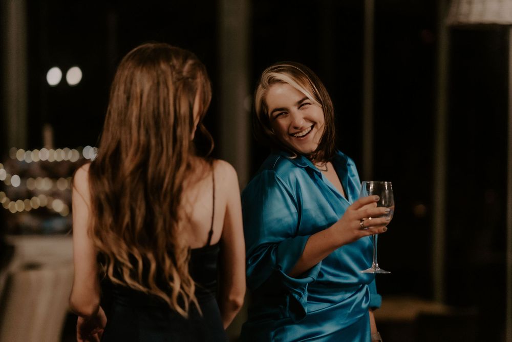 Candid moments of guests enjoying themselves at a wedding reception.