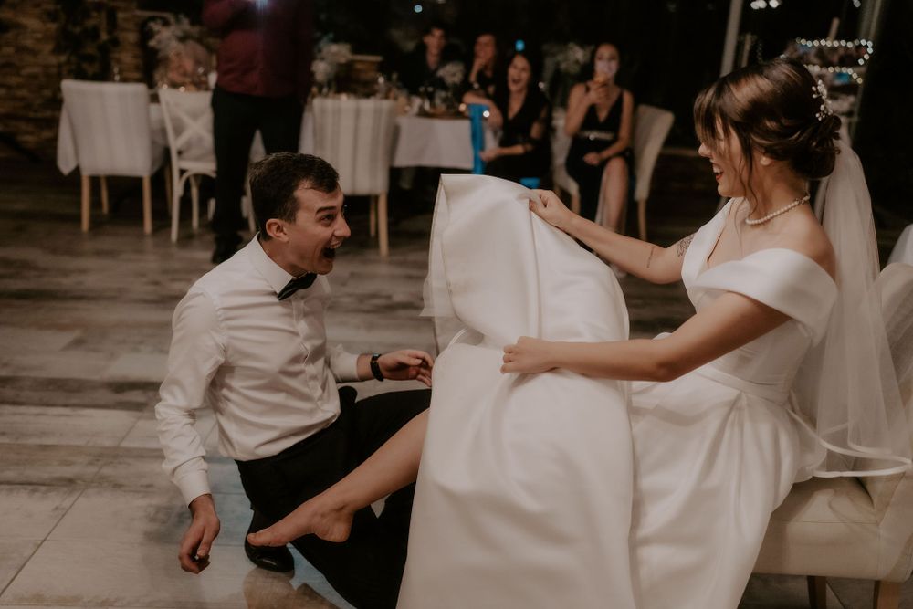 A playful wedding dance moment captured between the bride and groom on the dance floor.