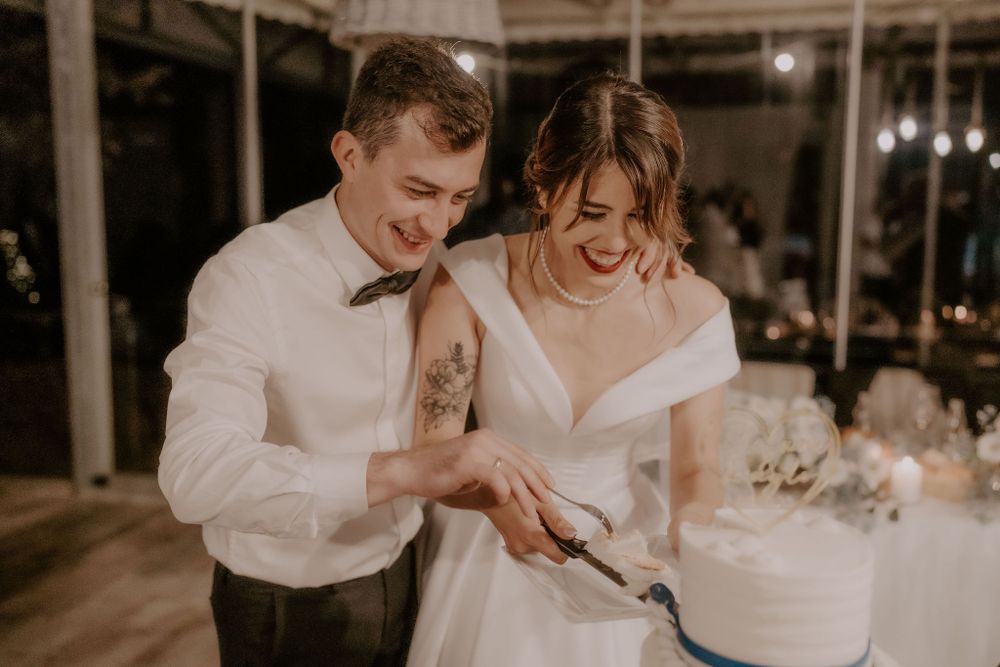 Wedding couple shares intimate dance under warm lighting at indoor reception venue.