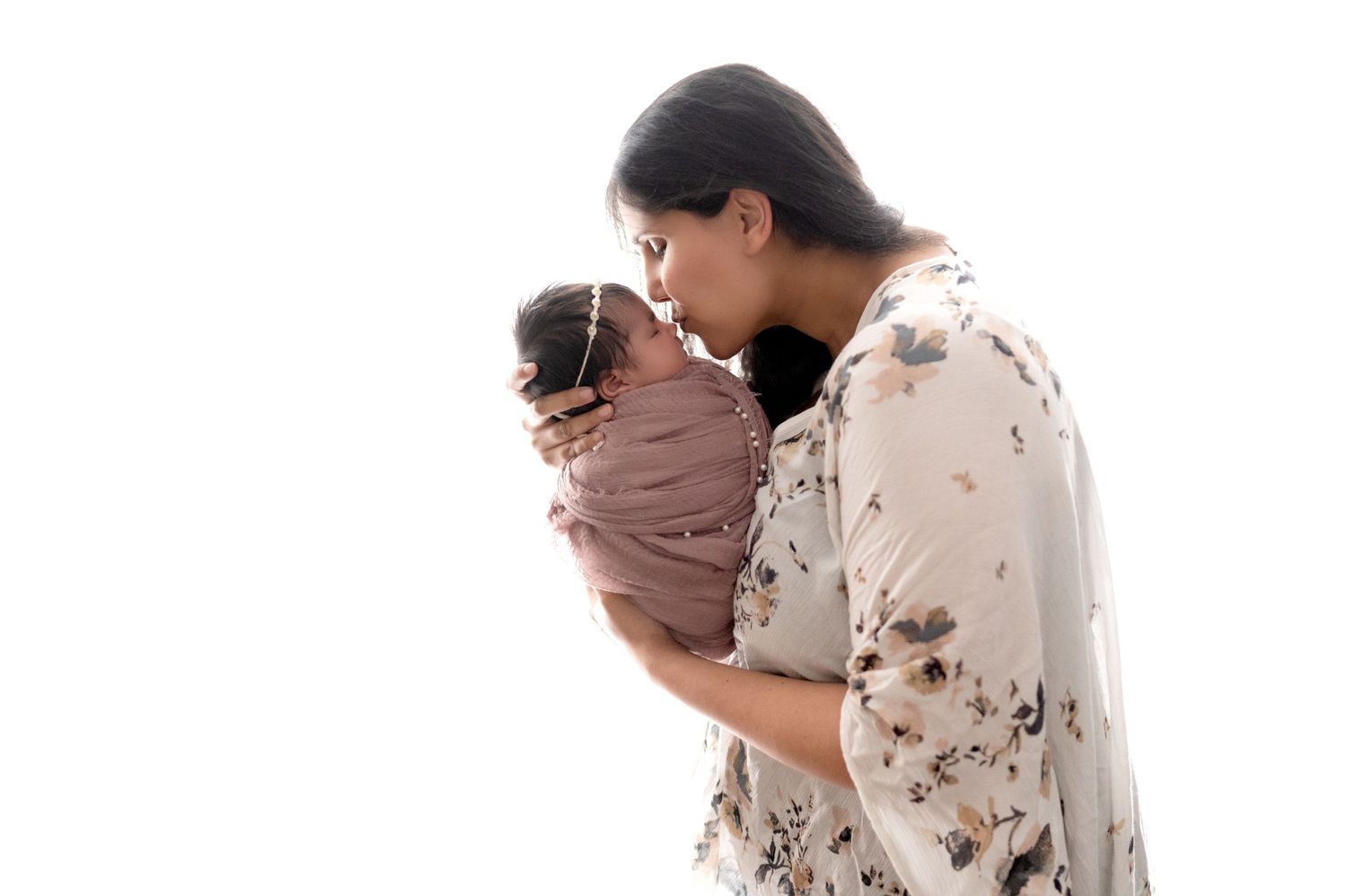 Candid family moment with newborn baby during professional photo session.