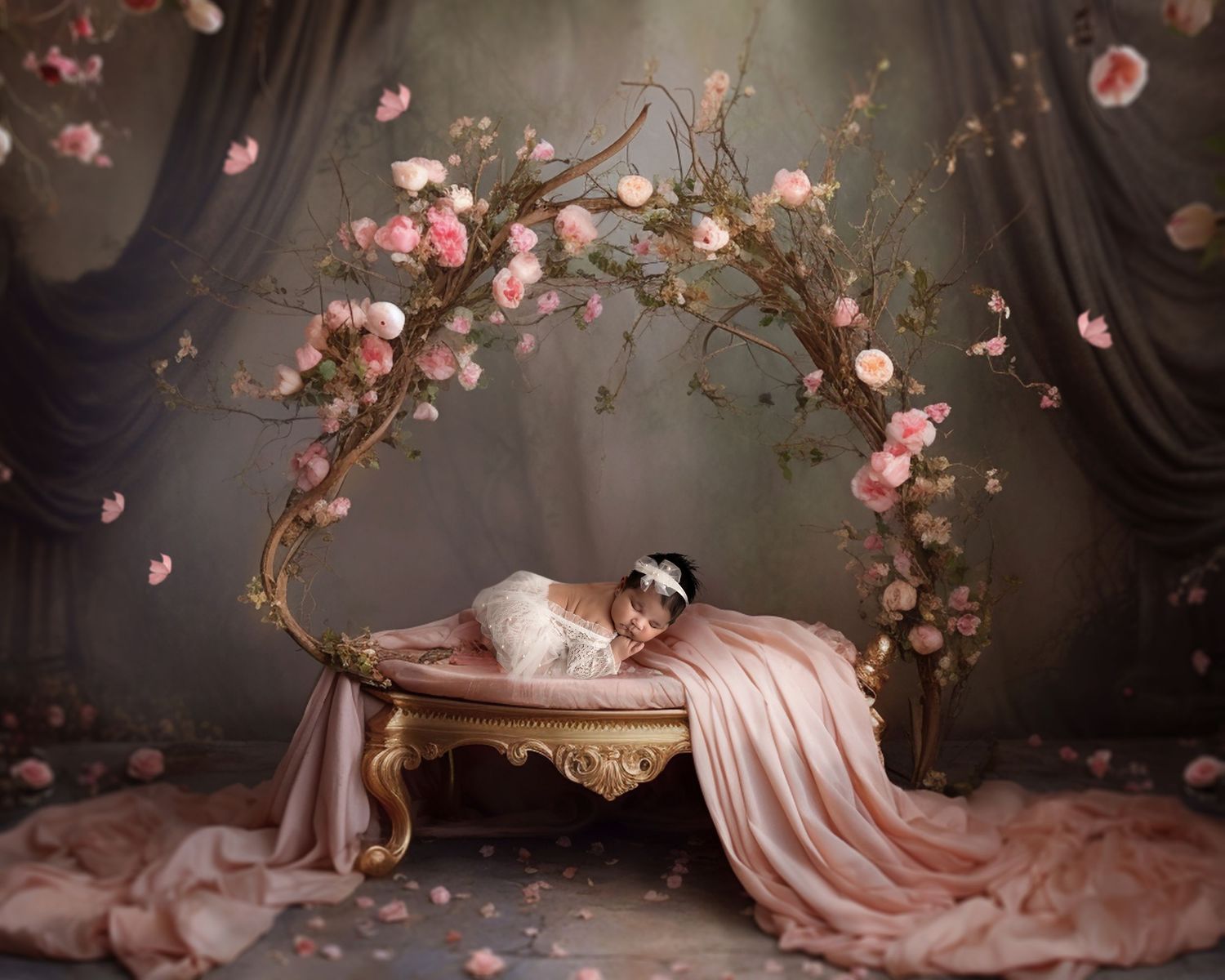 Dreamy portrait of sleeping figure on elegant chaise draped in pink silk with cherry blossoms arching overhead.