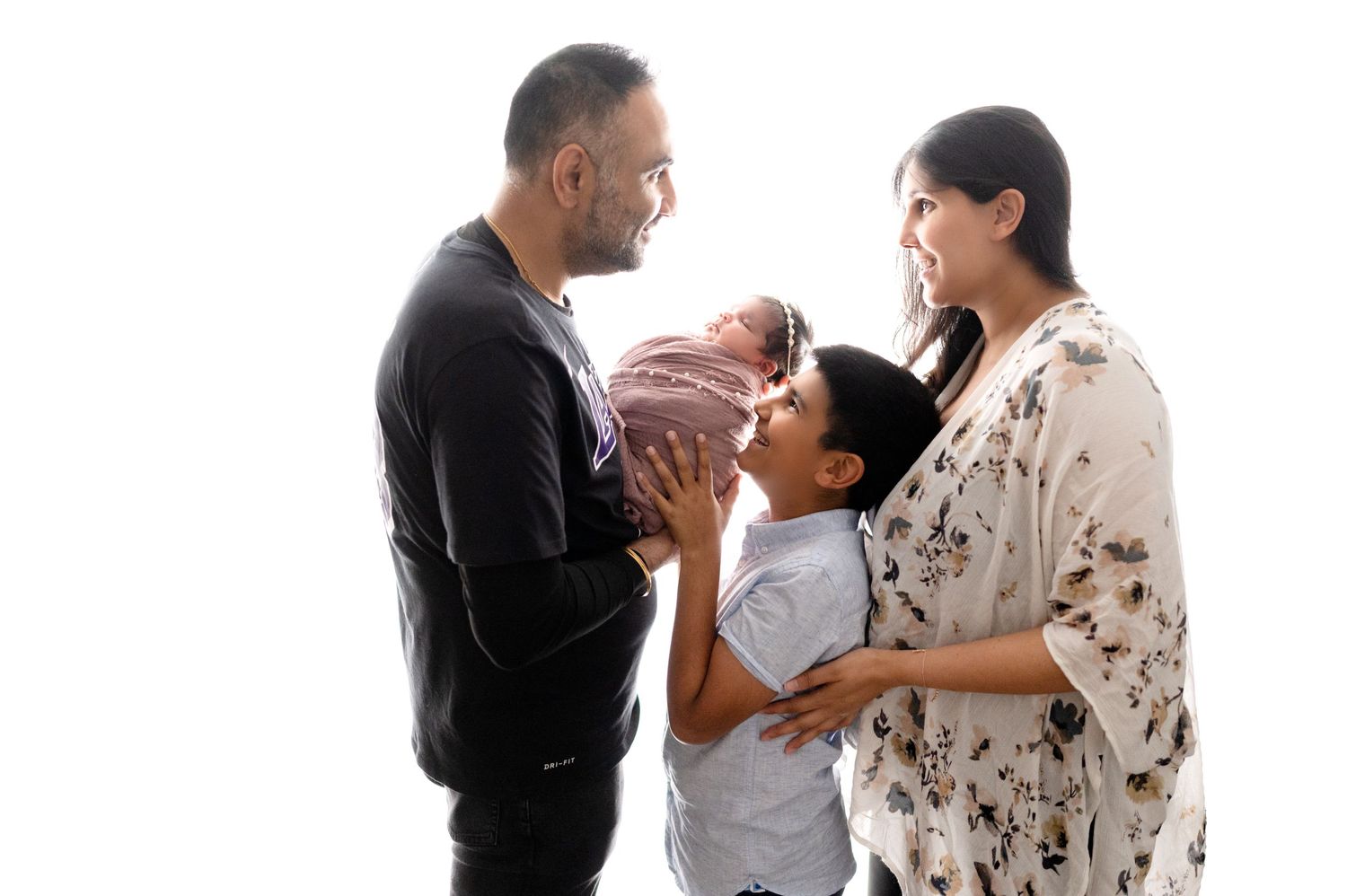 Emotional family photography session showing tender moments with newborn.