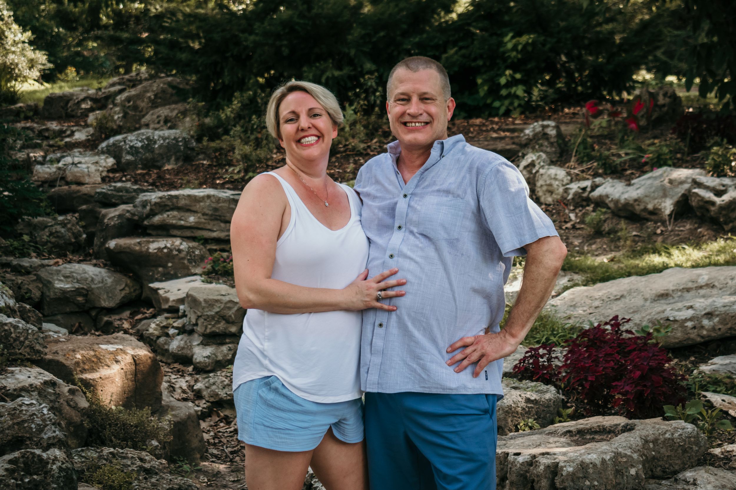 An older couple pose together, enjoying the warm summer evening