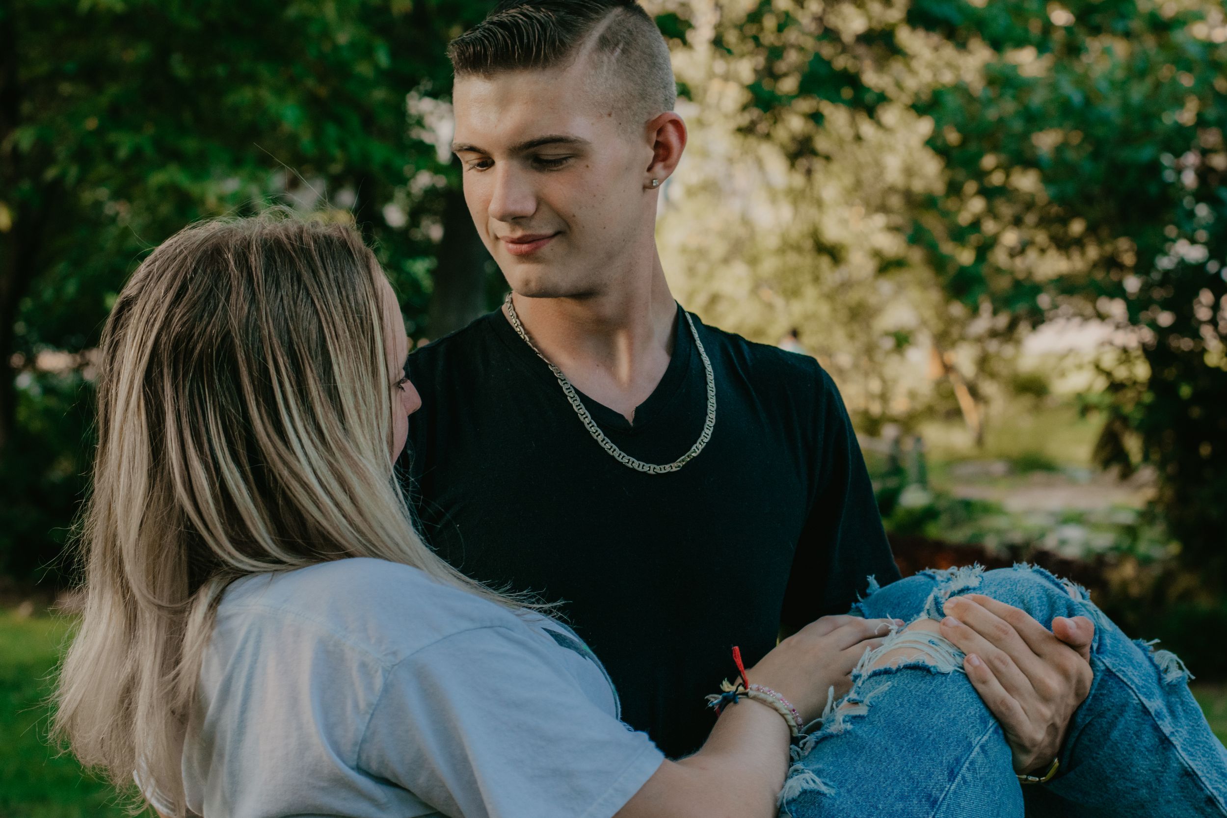 A quiet moment of young love between two teens during a senior photo shoot