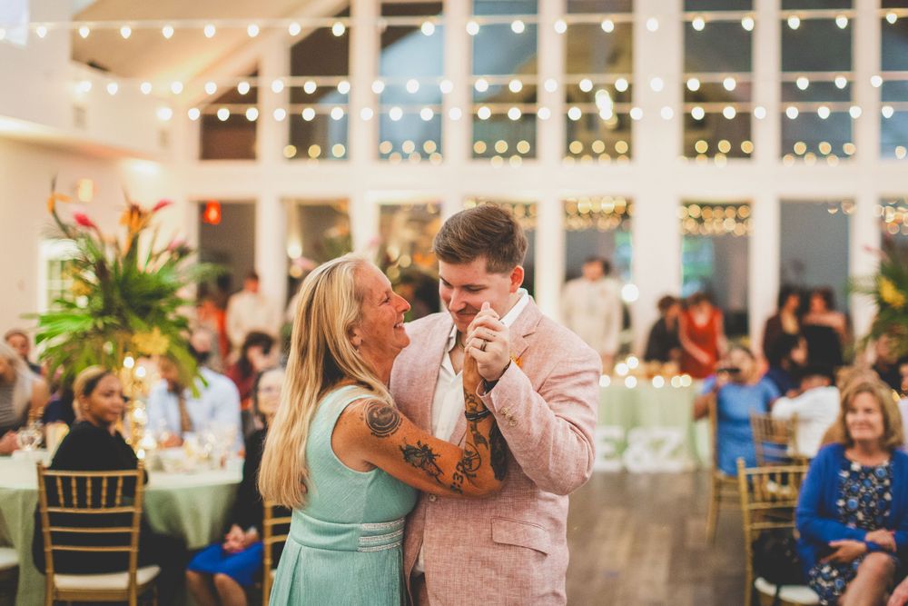 A couple sharing a dance in formal attire at an elegant reception venue.