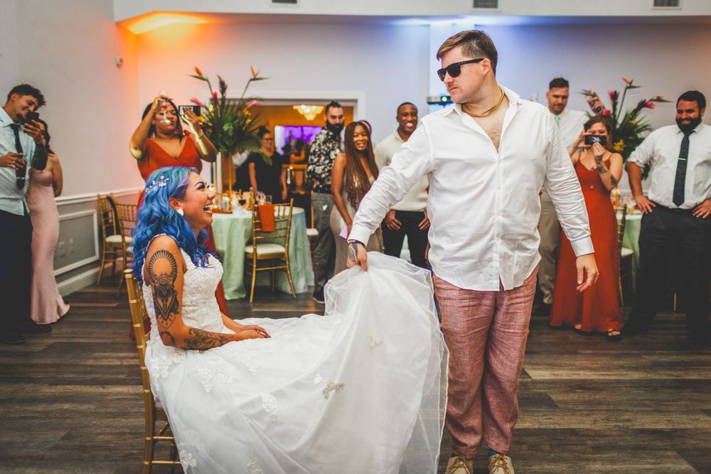 Dancing guests celebrate on the dance floor at a wedding reception.