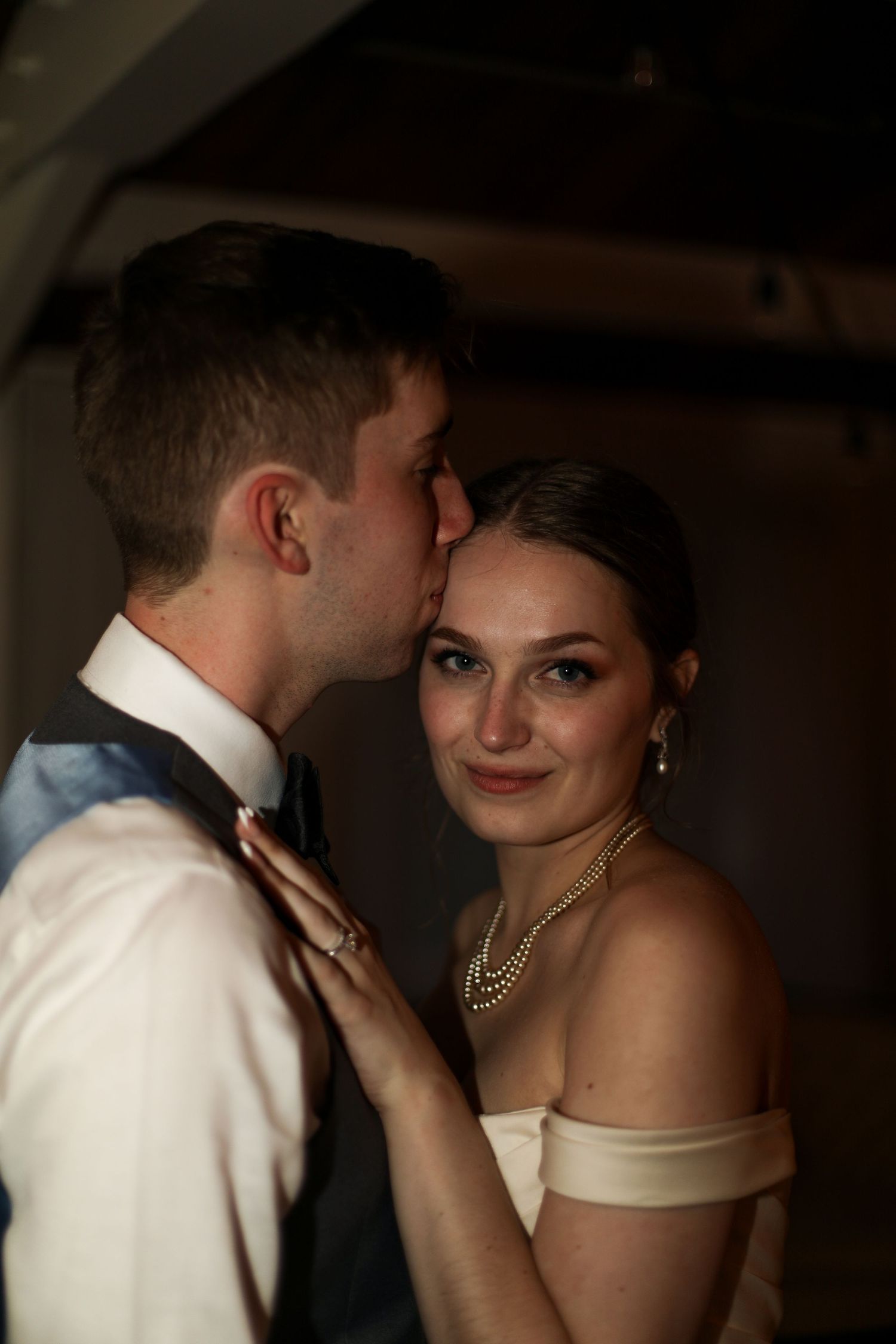 Romantic wedding portrait in warm lighting capturing an intimate moment.