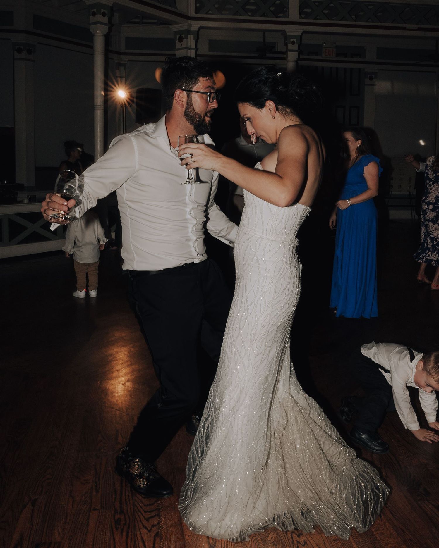 A couple shares an intimate slow dance moment during a wedding reception.