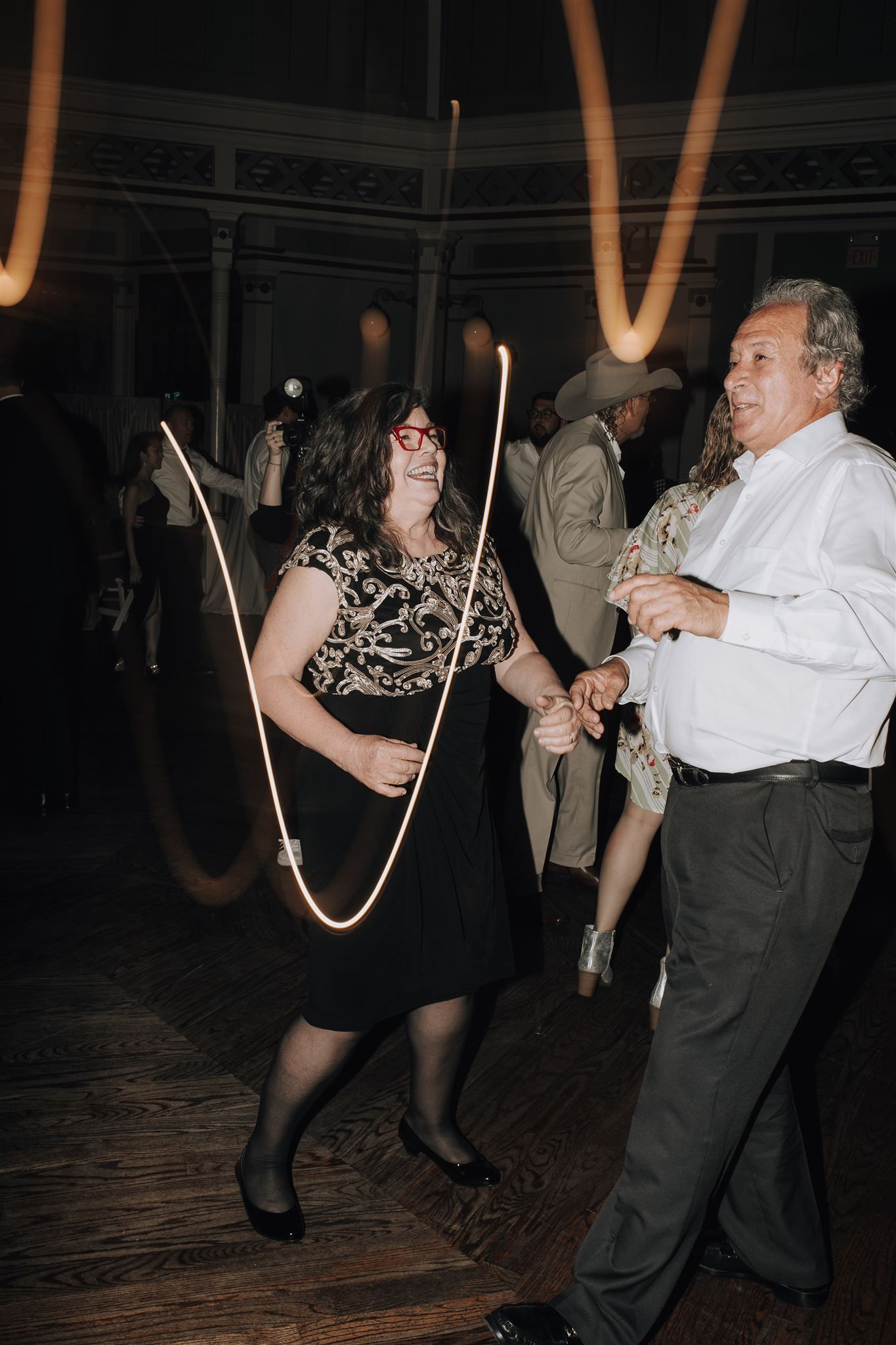 Wedding guests playing with jump ropes during a fun dance floor moment.