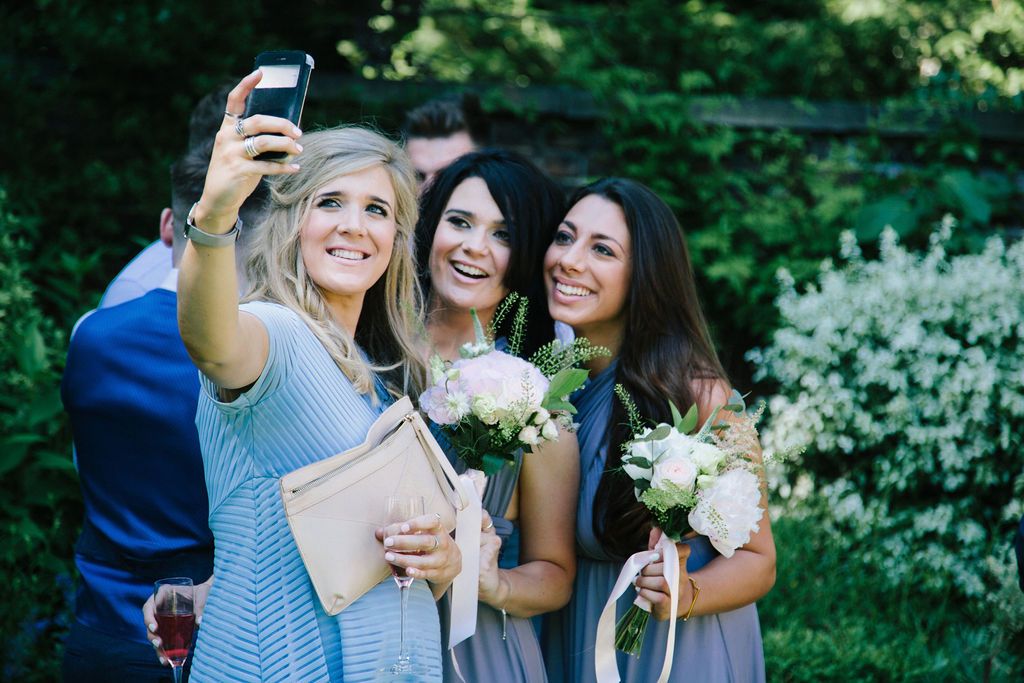 Guests at a wedding taking a selfie