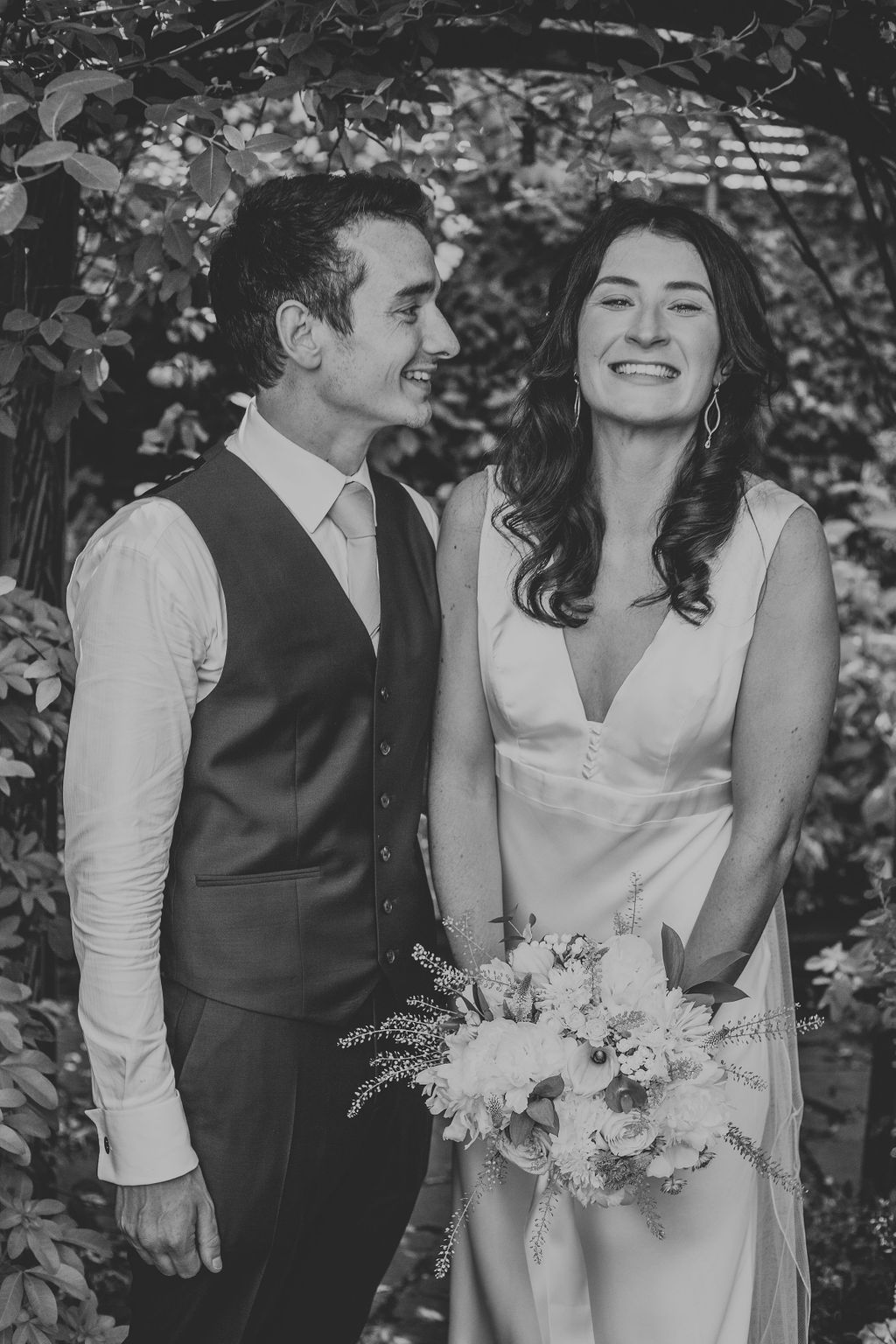 Black and white of bride and groom smiling