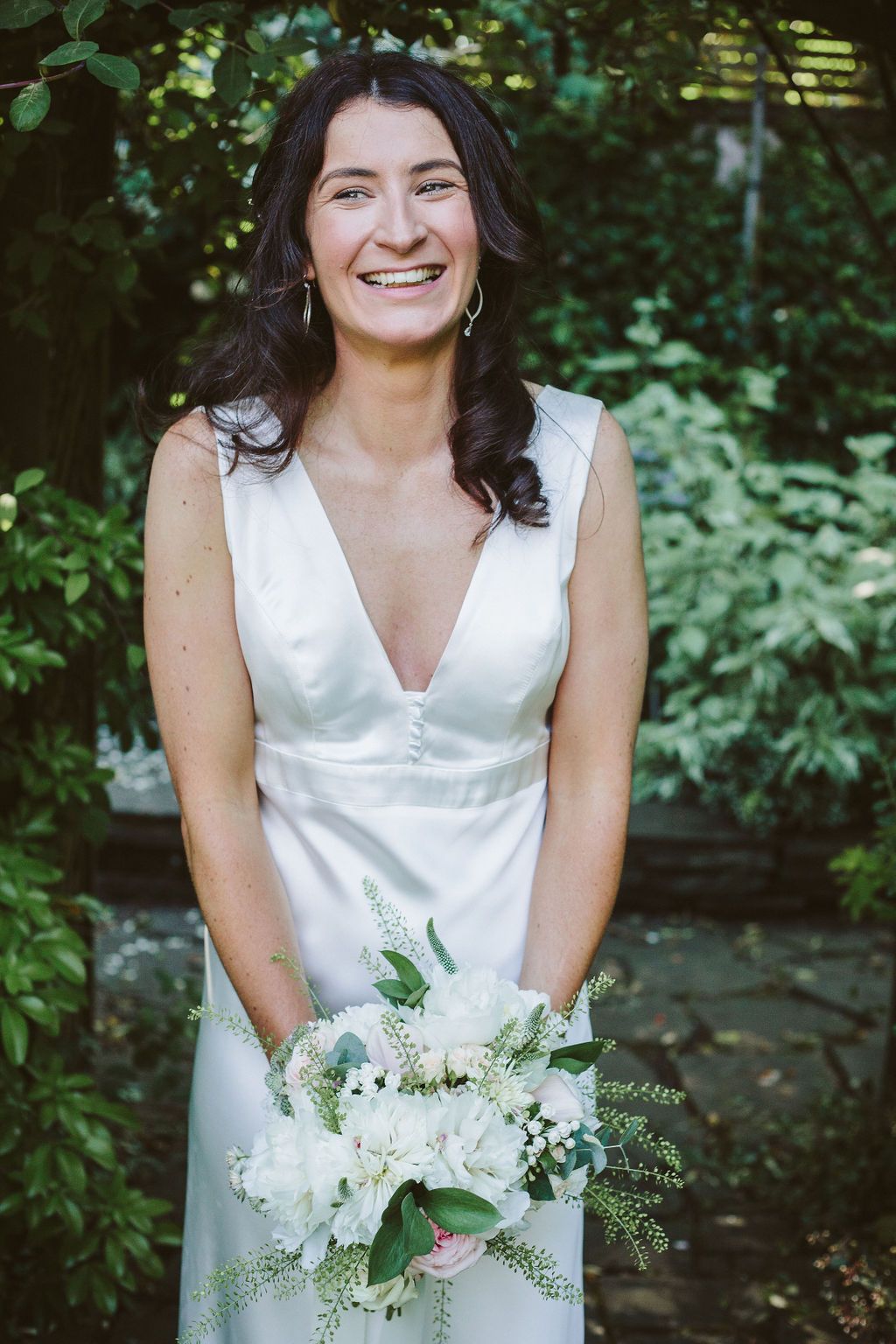 Bride smiling with her flowers
