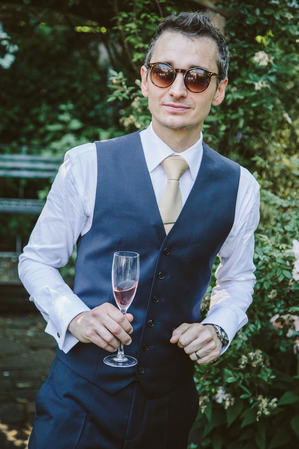 Groom holding a glass of fizz