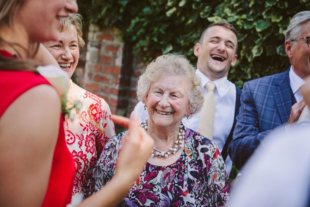 Grandma smiling at laughing at a wedding