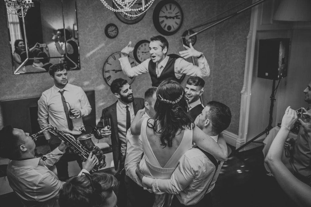 Groom on shoulders on the dance floor