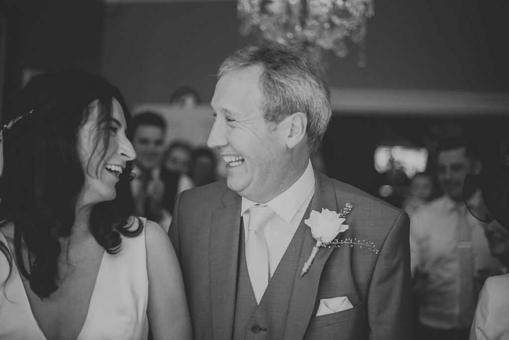 Father of bride walking with bride down the aisle