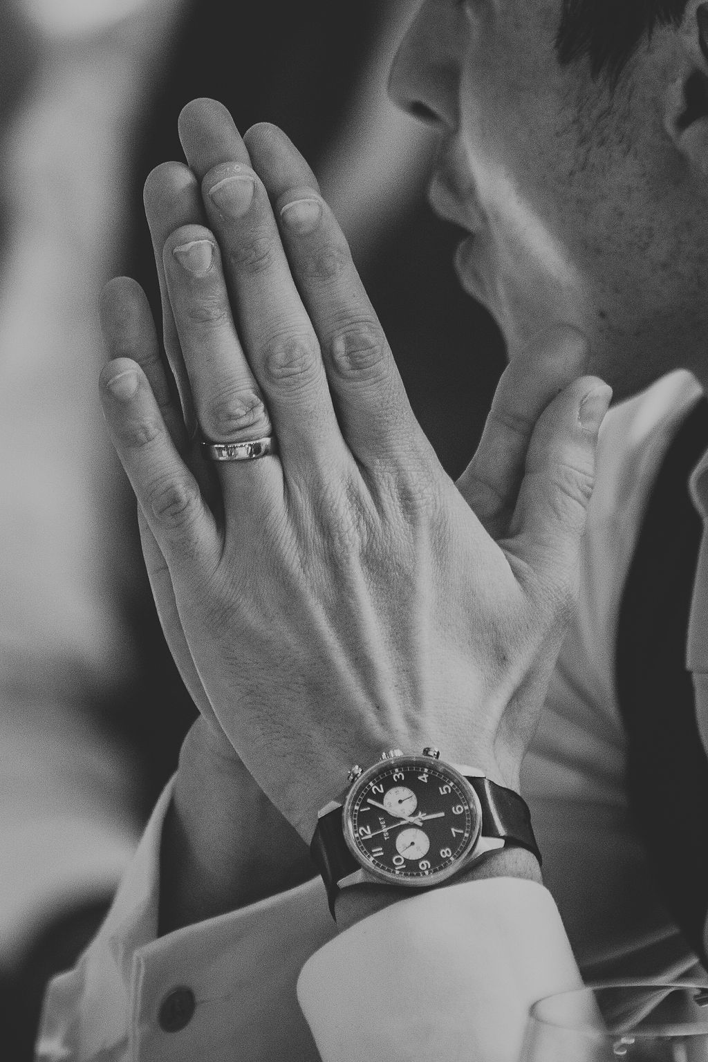 Close up of grooms hand with watch and wedding ring
