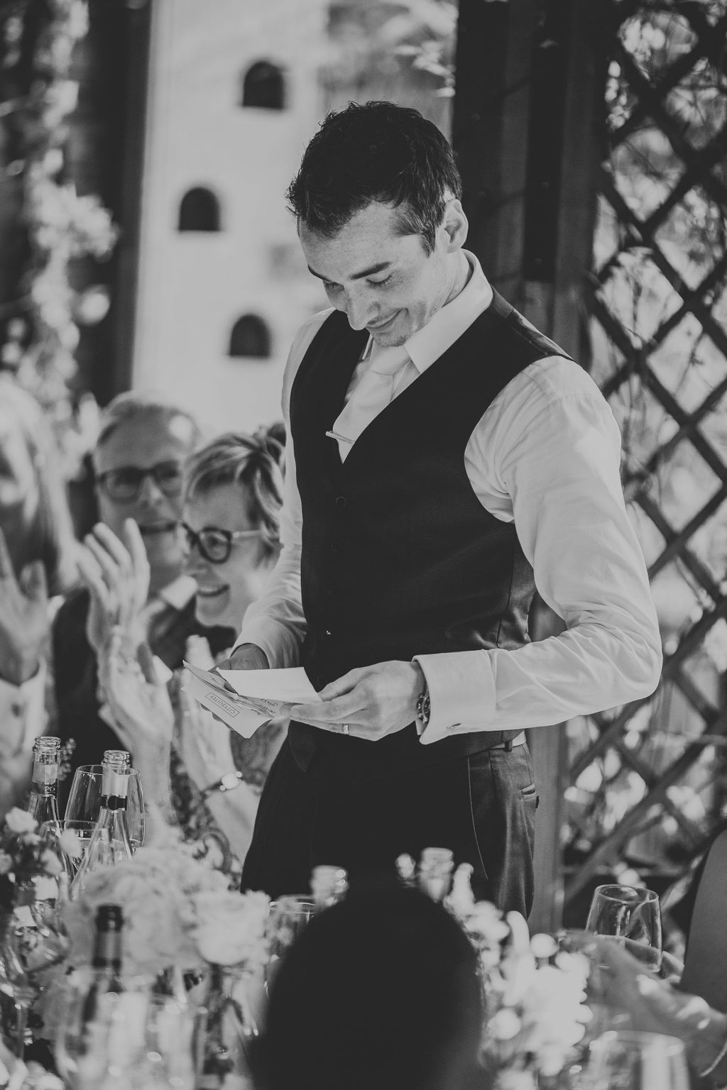 Black and white of groom doing his speech