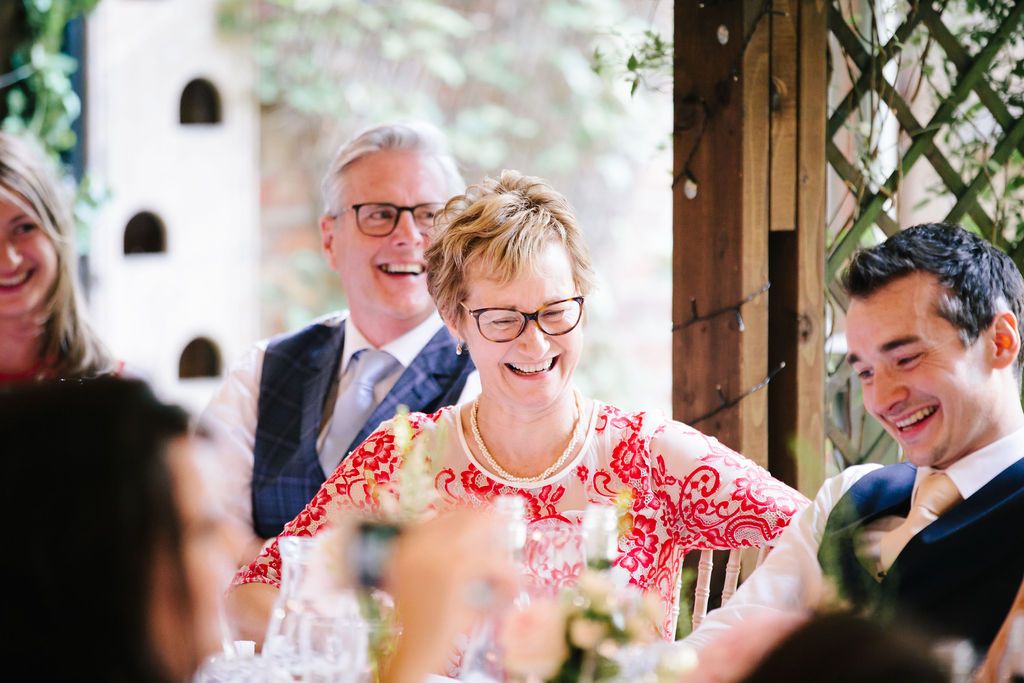 Groom with his parents laughing