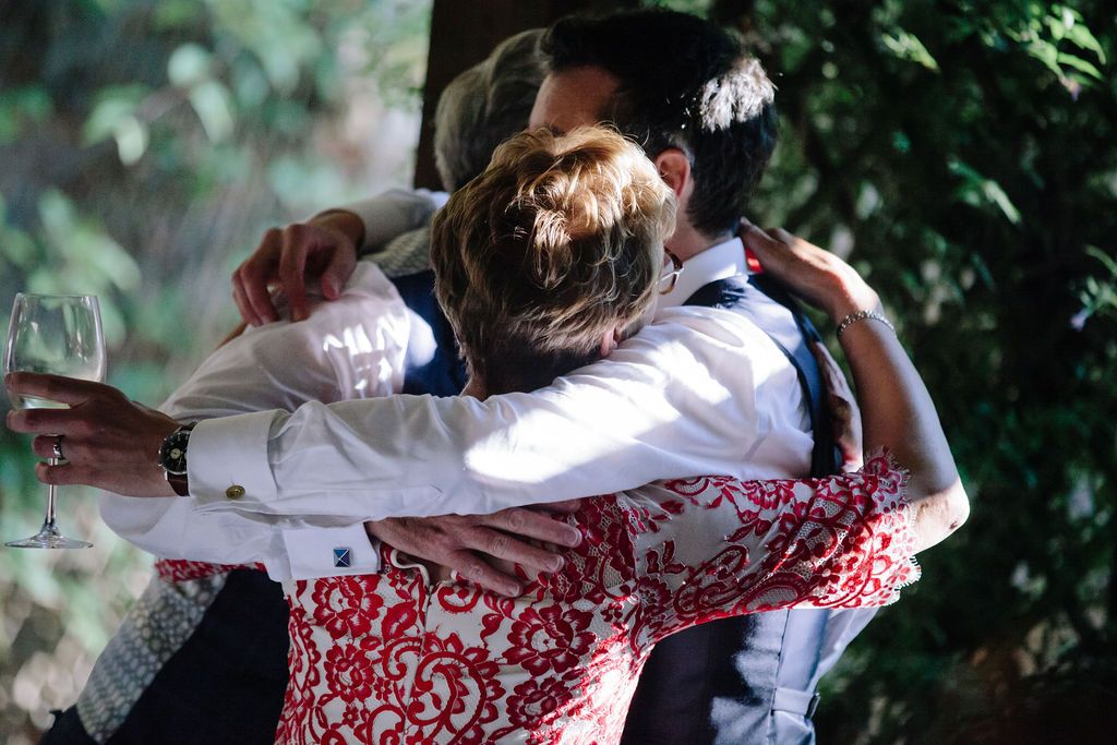Groom hugging his mum and dad
