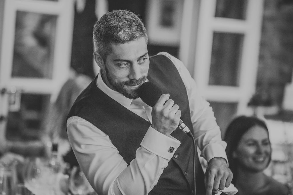 Black and white of best man doing is speech