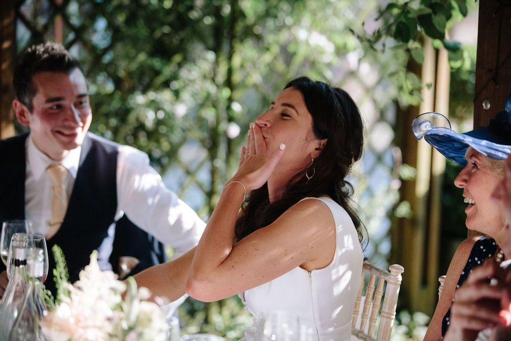 Bride laughing at best man speech