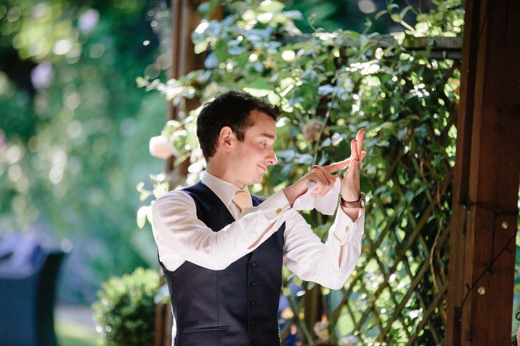 Groom pointing at his ring