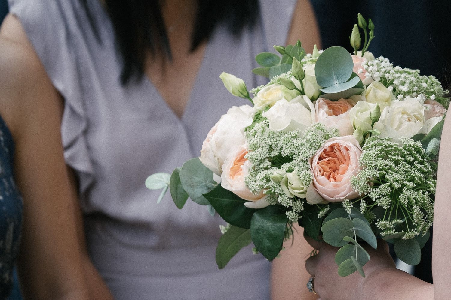 floral wedding bouquet featuring pastel coloured roses