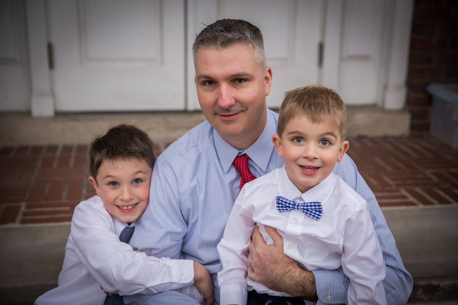 dad with young boys dressed in shirts and ties