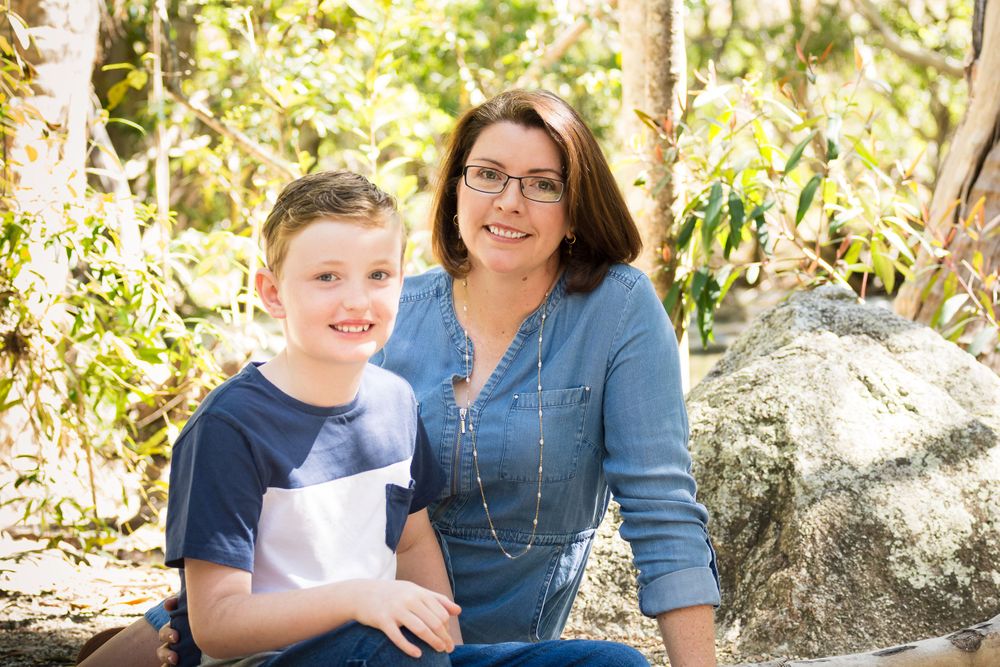 Family enjoying a casual moment together on rocky natural terrain.