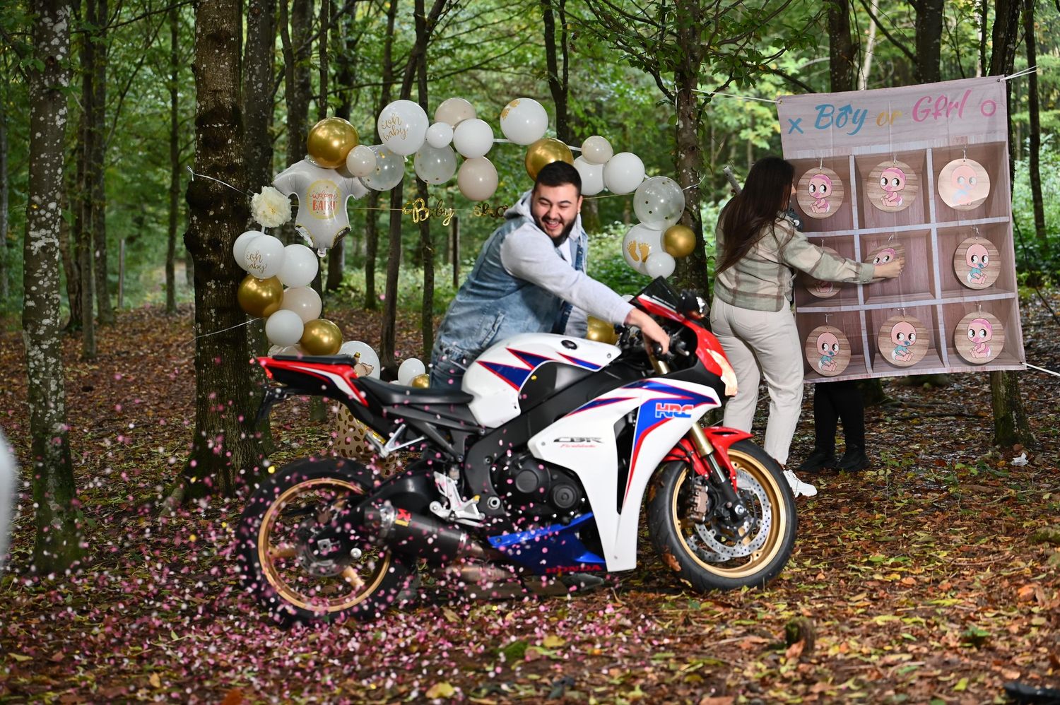 Motorcycle gathering in wooded area decorated with white balloons and party decorations.