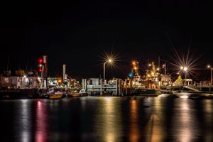 Plymouth Harbor at night with festive lights from the barges