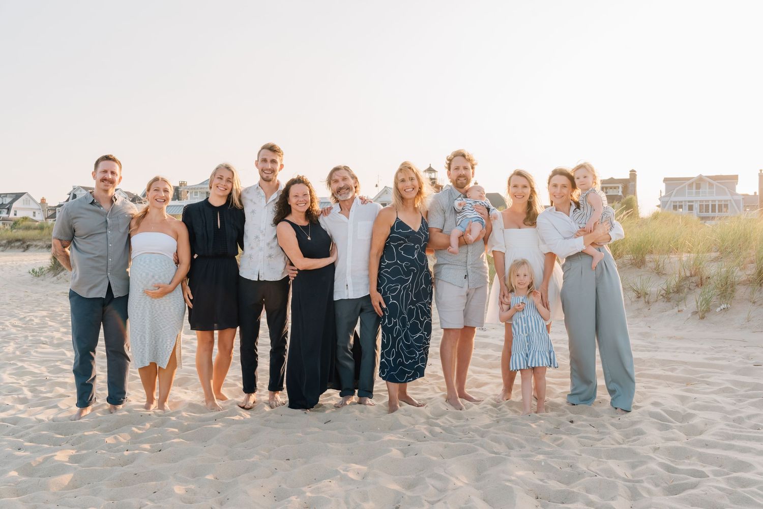 A large family gathers at a NJ beach for family photos with their grandchildren.